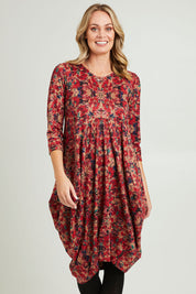 Model Grace wearing size 10 of the Bounce Dress in colour Red (Red), from the front, cropped image