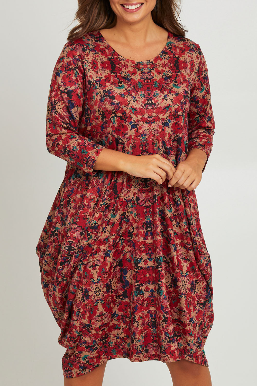 Model Monique wearing size 14 of the Bounce Dress in colour Red (Red), from the front, cropped image