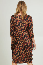 Model Grace wearing size 10 of the Bounce Dress in colour Rust (Black), from the back