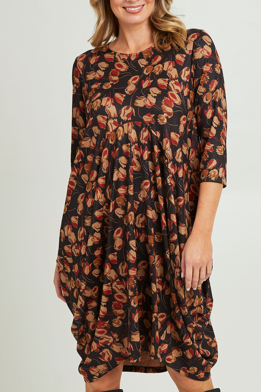 Model Grace wearing size 10 of the Bounce Dress in colour Rust (Black), from the front, cropped image