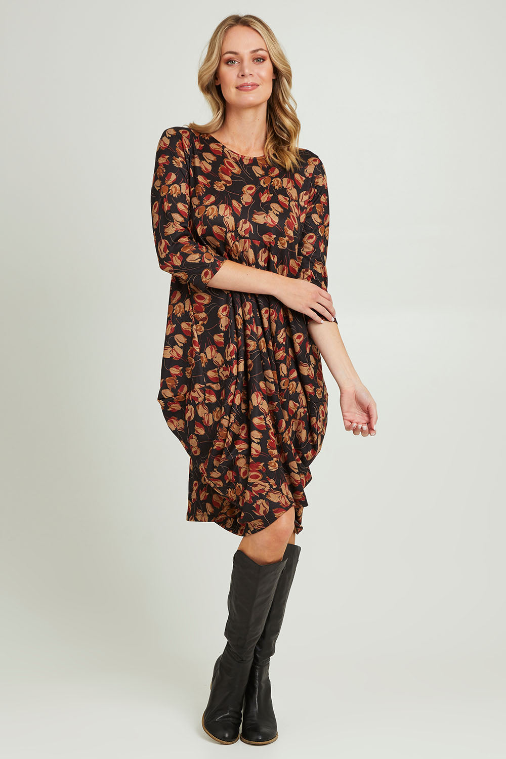 Model Grace wearing size 10 of the Bounce Dress in colour Rust (Black), from the front, showing the whole outfit