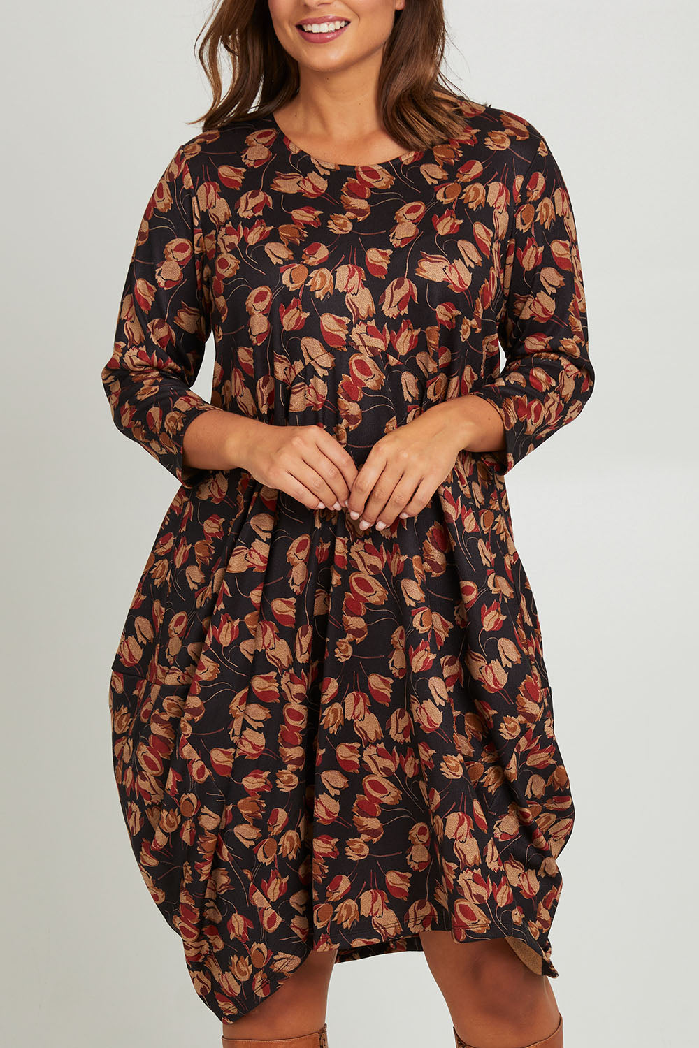 Model Monique wearing size 14 of the Bounce Dress in colour Rust (Black), from the front, cropped image