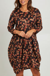 Model Monique wearing size 14 of the Bounce Dress in colour Rust (Black), from the front, cropped image