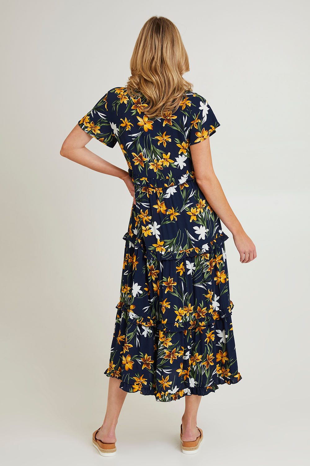 Model Grace wearing size 10 of the Printed Tier Dress in colour Navylemon (Blue), from the back