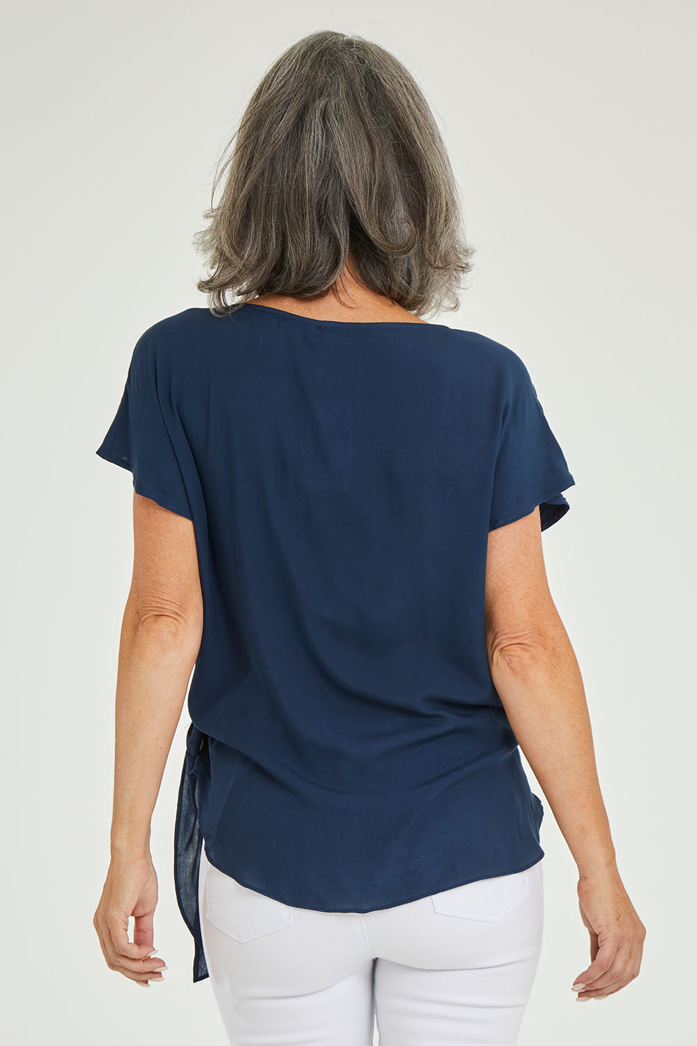 Model Luisa wearing size 10 of the Bora Bora Top in colour Navy (Blue), from the back