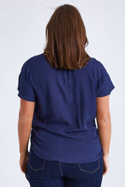 Model Monique wearing size 14 of the Bora Bora Top in colour Navy (Blue), from the back