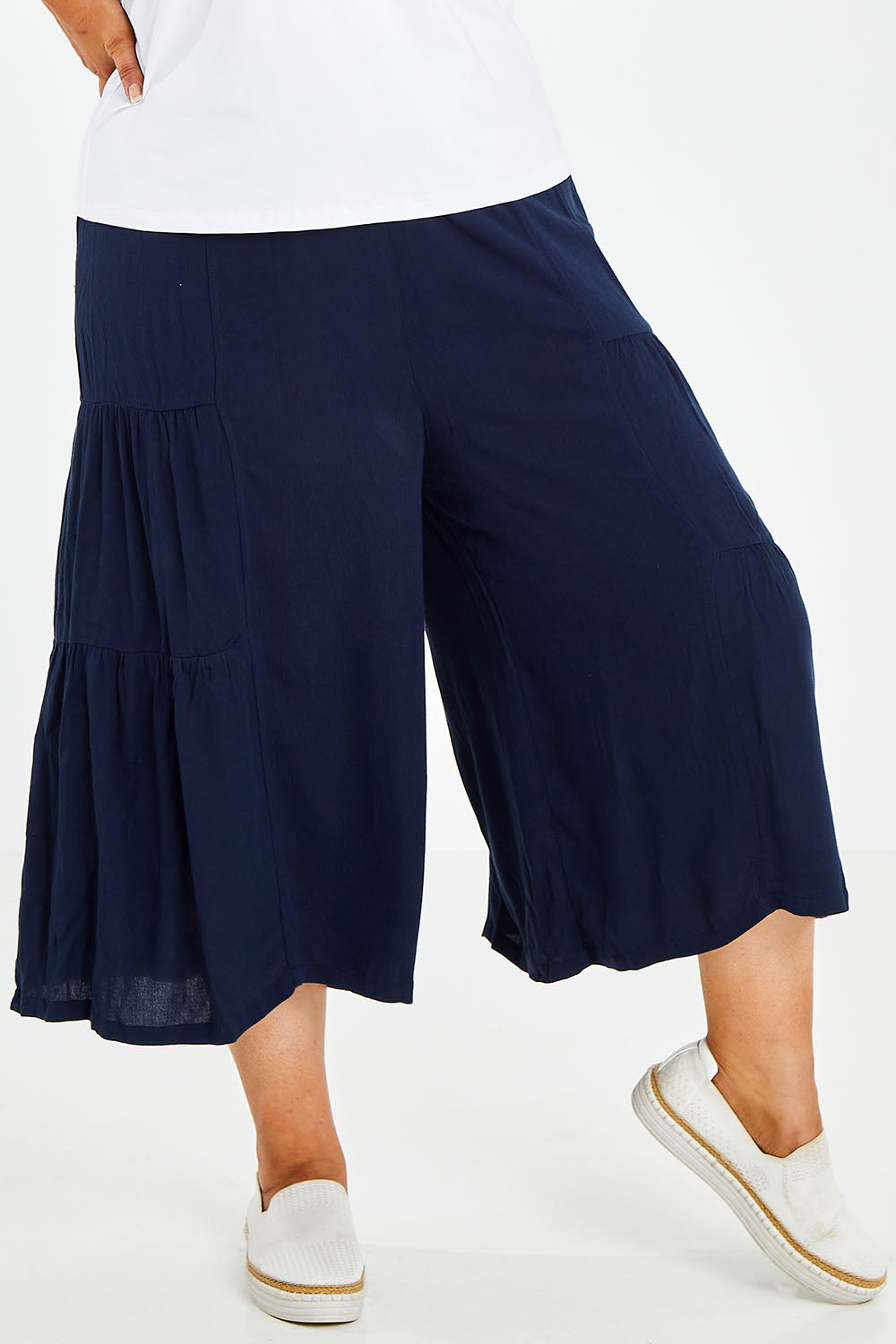 Model Jess wearing size 14 of the Gaucho Pant in colour Navy (Blue), from the front, cropped image