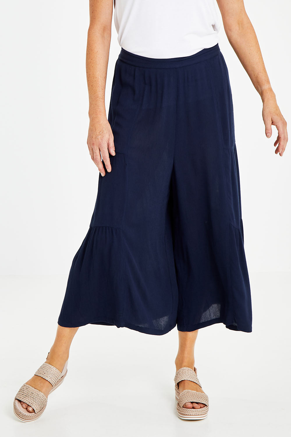 Model Naomi wearing size 10 of the Gaucho Pant in colour Navy (Blue), from the front, cropped image