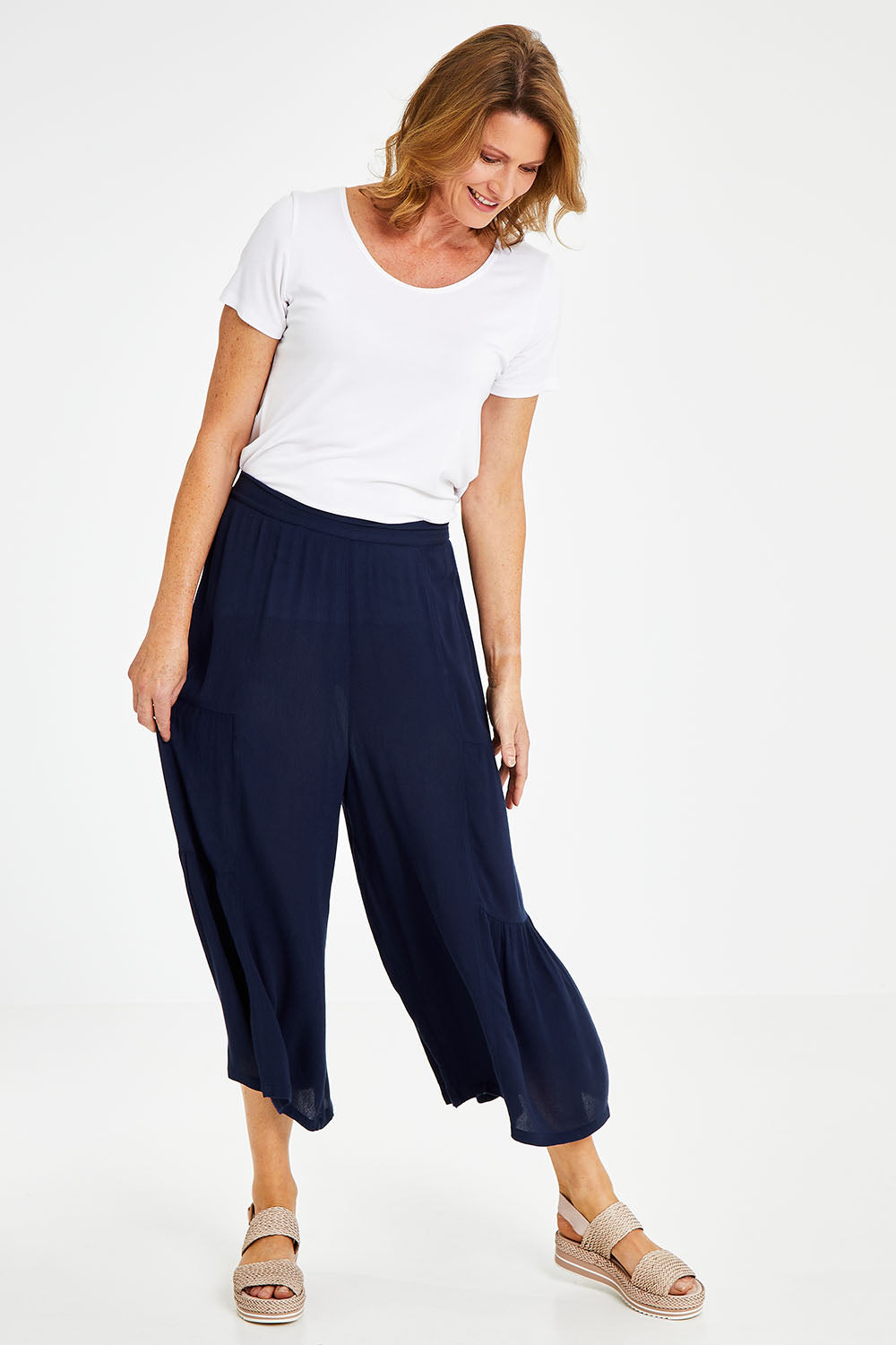 Model Naomi wearing size 10 of the Gaucho Pant in colour Navy (Blue), from the front, showing the whole outfit