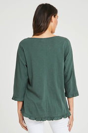 Model Madeline wearing size 10 of the Ruffle 3/4 Sleeve Top in colour Forest (Green), from the back