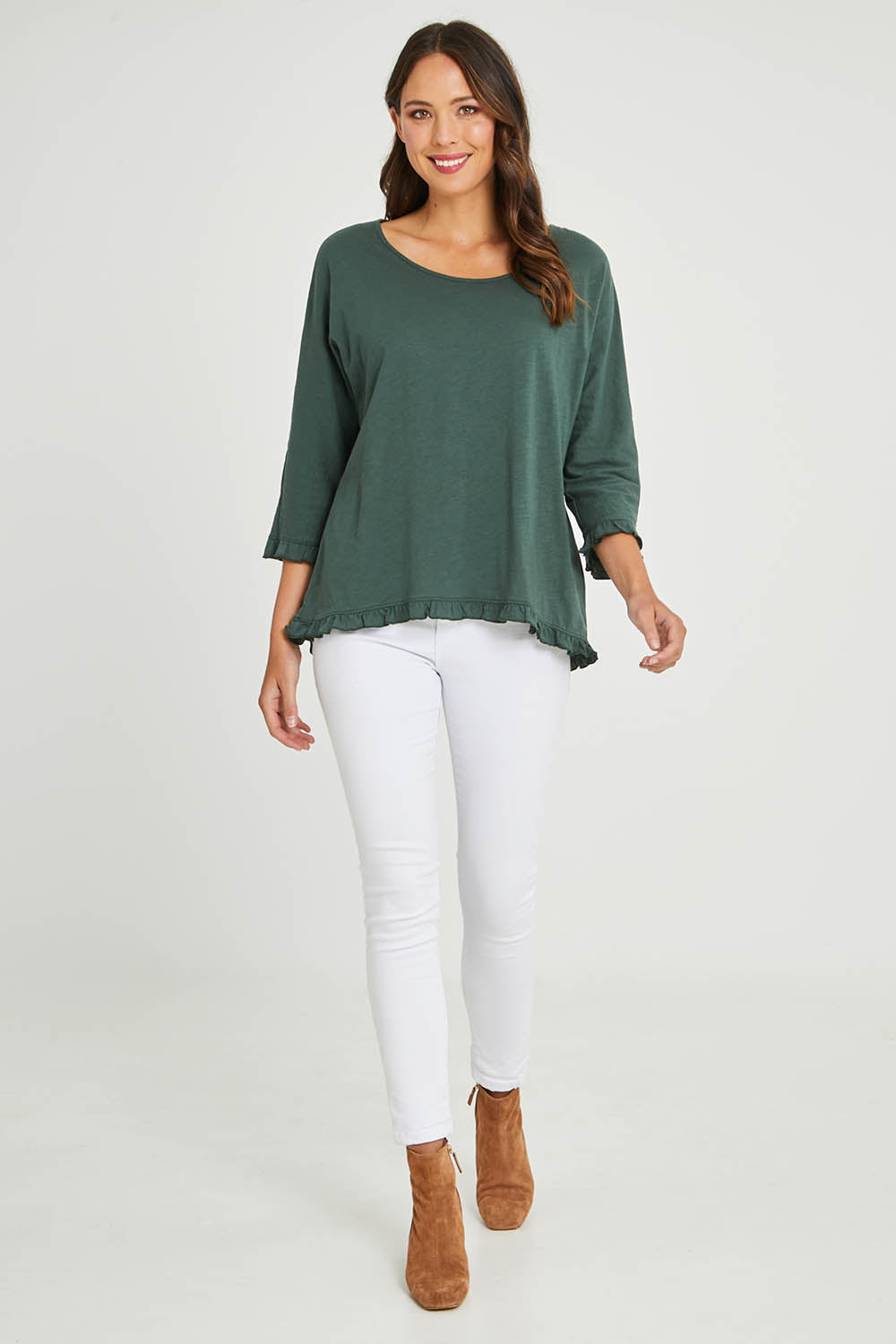 Model Madeline wearing size 10 of the Ruffle 3/4 Sleeve Top in colour Forest (Green), from the front, showing the whole outfit