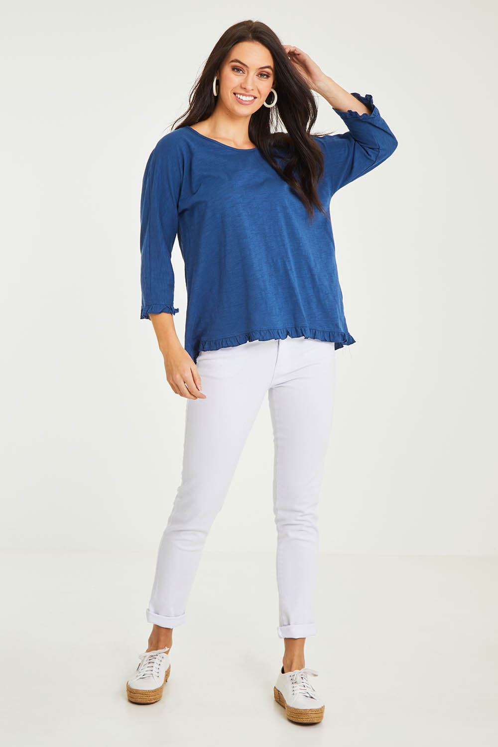 Model Stacey wearing size 10 of the Ruffle 3/4 Sleeve Top in colour Navy (White), from the front, showing the whole outfit