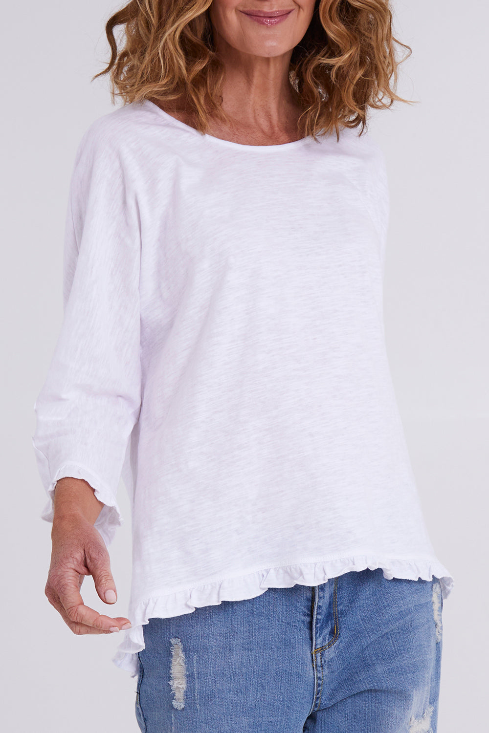 Model Emma wearing size 10 of the Ruffle 3/4 Sleeve Top in colour White (White), from the front, cropped image
