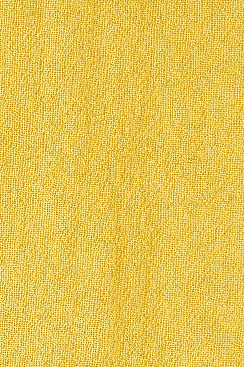 Product shot of the Upcycle Cowly Top in colour Sunflower, detail