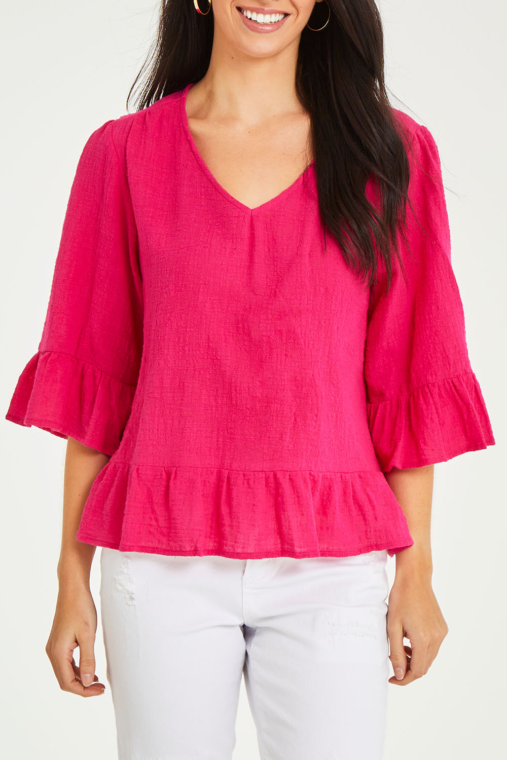 Model Stacey wearing size 10 of the Ruffle Top in colour Hotpink (Pink), from the front, cropped image
