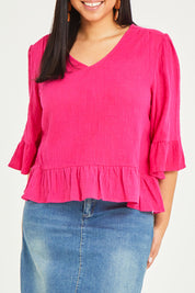 Model Terri-Leigh wearing size 14 of the Ruffle Top in colour Hotpink (Pink), from the front, cropped image
