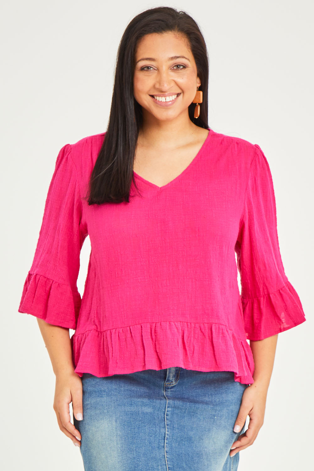 Model Terri-Leigh wearing size 14 of the Ruffle Top in colour Hotpink (Pink), from the front, cropped image
