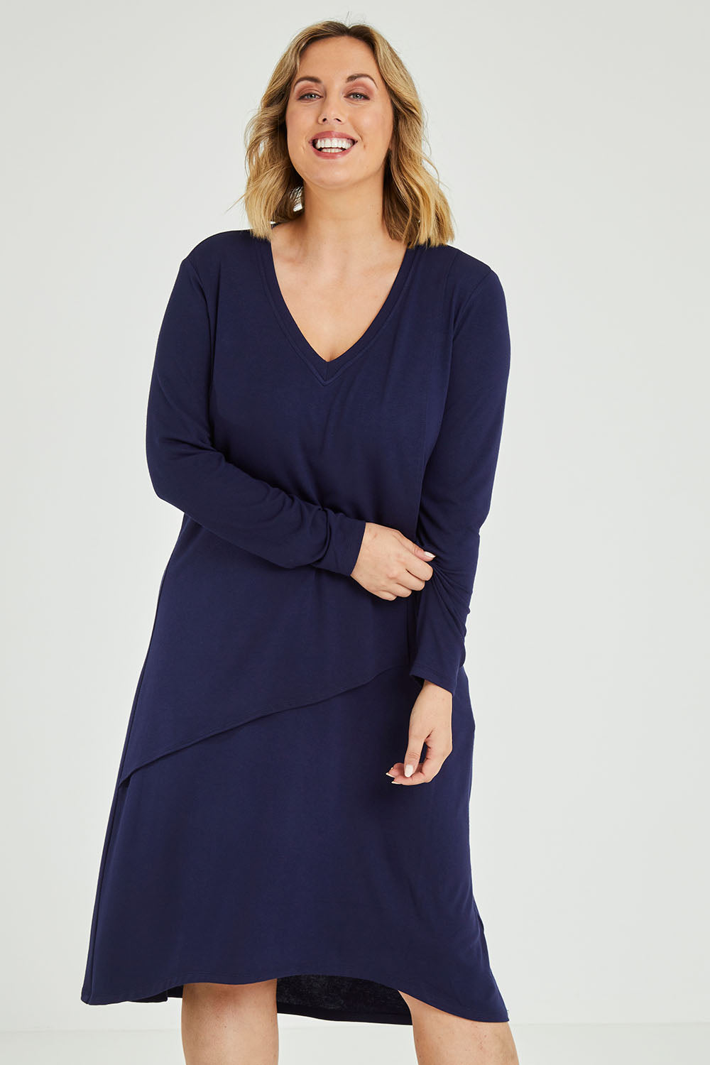 Model Jess wearing size 14 of the Overlay Dress in colour Navy (Blue), from the front, cropped image