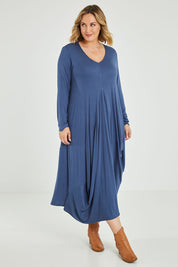 Model Jess wearing size 14 of the Jo Jo Core Dress in colour Petrol (Blue), from the front, showing the whole outfit