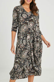 Model Madeline wearing size 10 of the Jo Jo Print Jersey Dress in colour Green (Green), from the front, cropped image