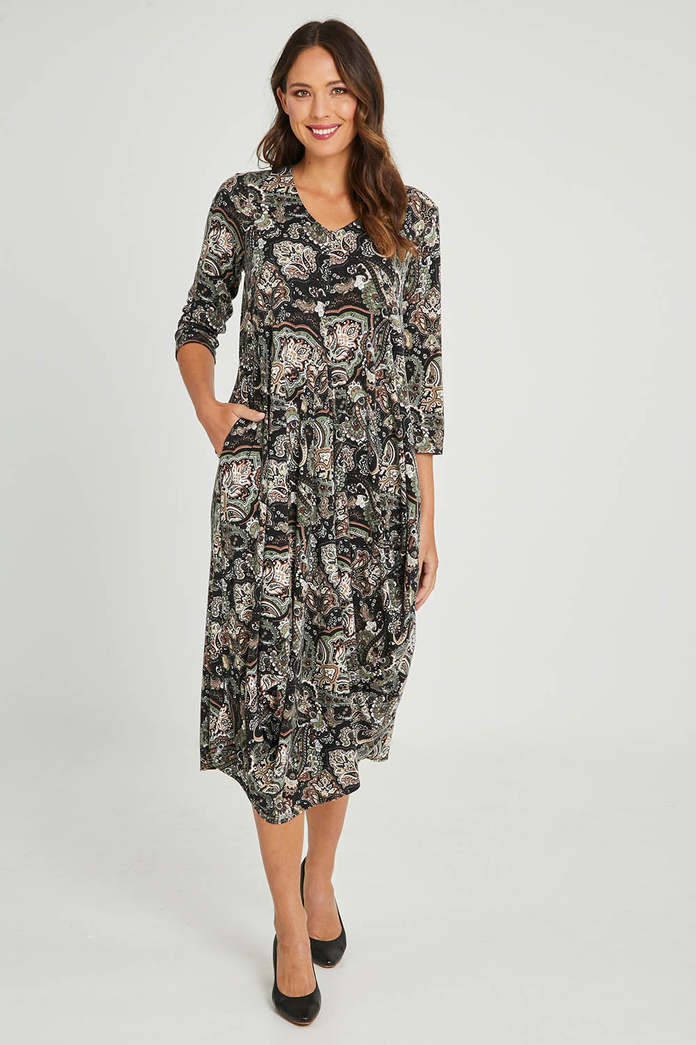 Model Madeline wearing size 10 of the Jo Jo Print Jersey Dress in colour Green (Green), from the front, showing the whole outfit