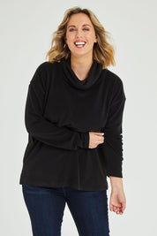 Model Jess wearing size 14 of the Micro Fleece Cowl in colour Black (Black), from the front, cropped image