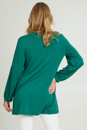 Model Grace wearing size 10 of the Hi Lo Knit Tunic in colour Forest (Green), from the back