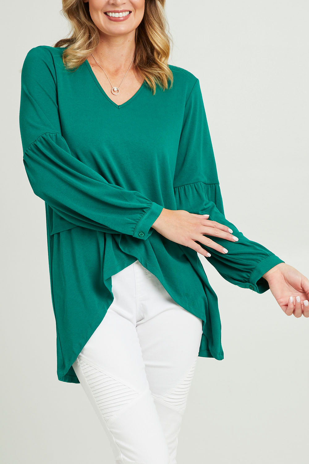 Model Grace wearing size 10 of the Hi Lo Knit Tunic in colour Forest (Green), from the front, cropped image