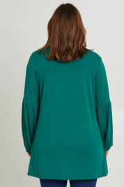 Model Monique wearing size 14 of the Hi Lo Knit Tunic in colour Forest (Green), from the back