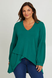 Model Monique wearing size 14 of the Hi Lo Knit Tunic in colour Forest (Green), from the front, cropped image