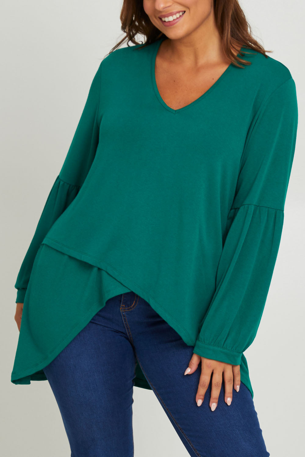 Model Monique wearing size 14 of the Hi Lo Knit Tunic in colour Forest (Green), from the front, cropped image