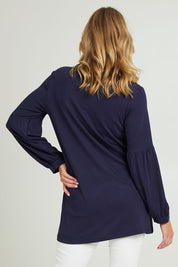 Model Grace wearing size 10 of the Hi Lo Knit Tunic in colour Navy (Blue), from the back