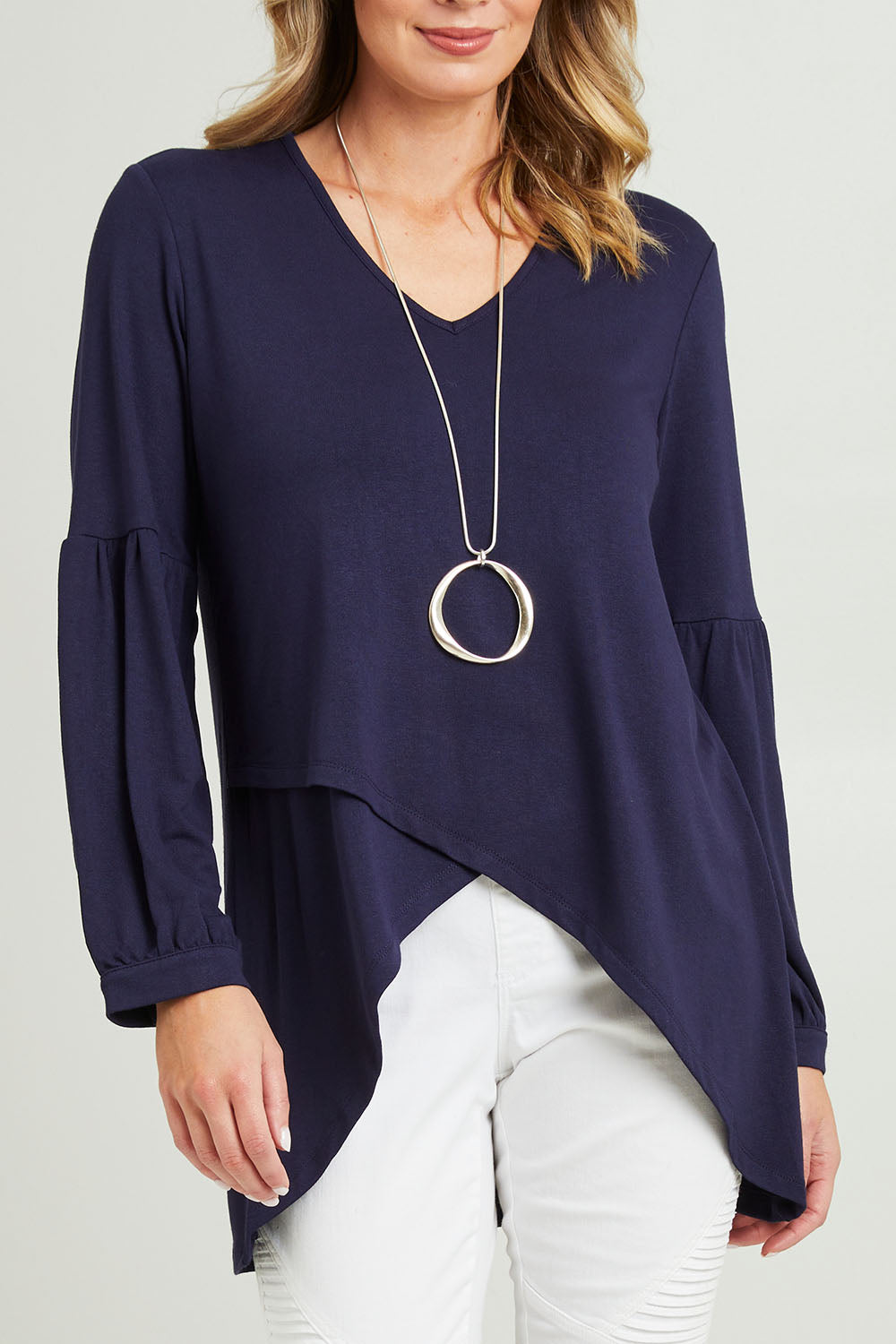 Model Grace wearing size 10 of the Hi Lo Knit Tunic in colour Navy (Blue), from the front, cropped image