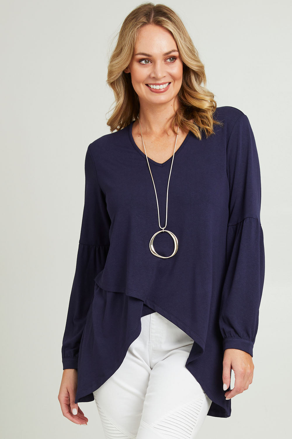Model Grace wearing size 10 of the Hi Lo Knit Tunic in colour Navy (Blue), from the front, cropped image