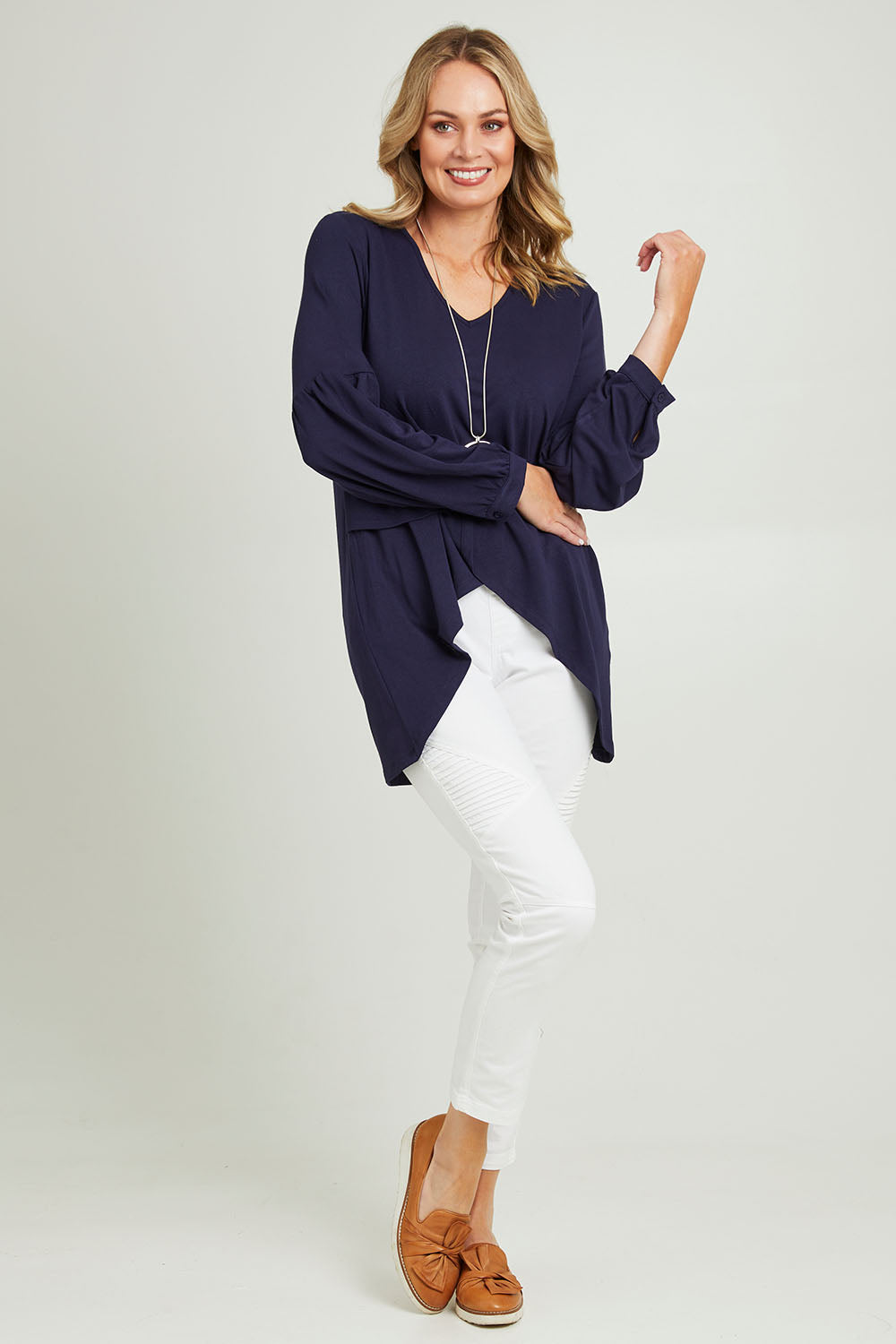 Model Grace wearing size 10 of the Hi Lo Knit Tunic in colour Navy (Blue), from the front, showing the whole outfit