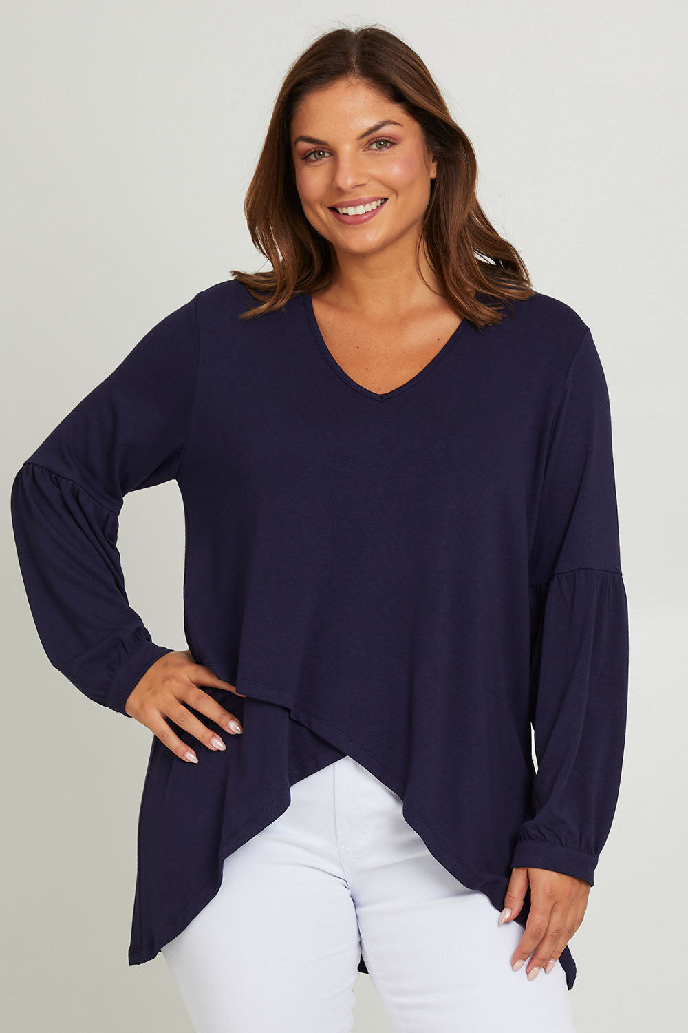 Model Monique wearing size 10 of the Hi Lo Knit Tunic in colour Navy (Blue), from the front, cropped image