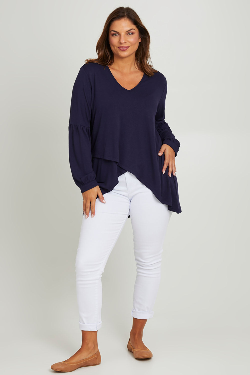 Model Monique wearing size 10 of the Hi Lo Knit Tunic in colour Navy (Blue), from the front, showing the whole outfit
