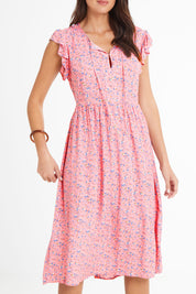 Model Madeline wearing size 10 of the Penny Dress in colour Pink (Pink), from the front, cropped image