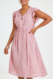 Model Noli wearing size 14 of the Penny Dress in colour Pink (Pink), from the front, cropped image