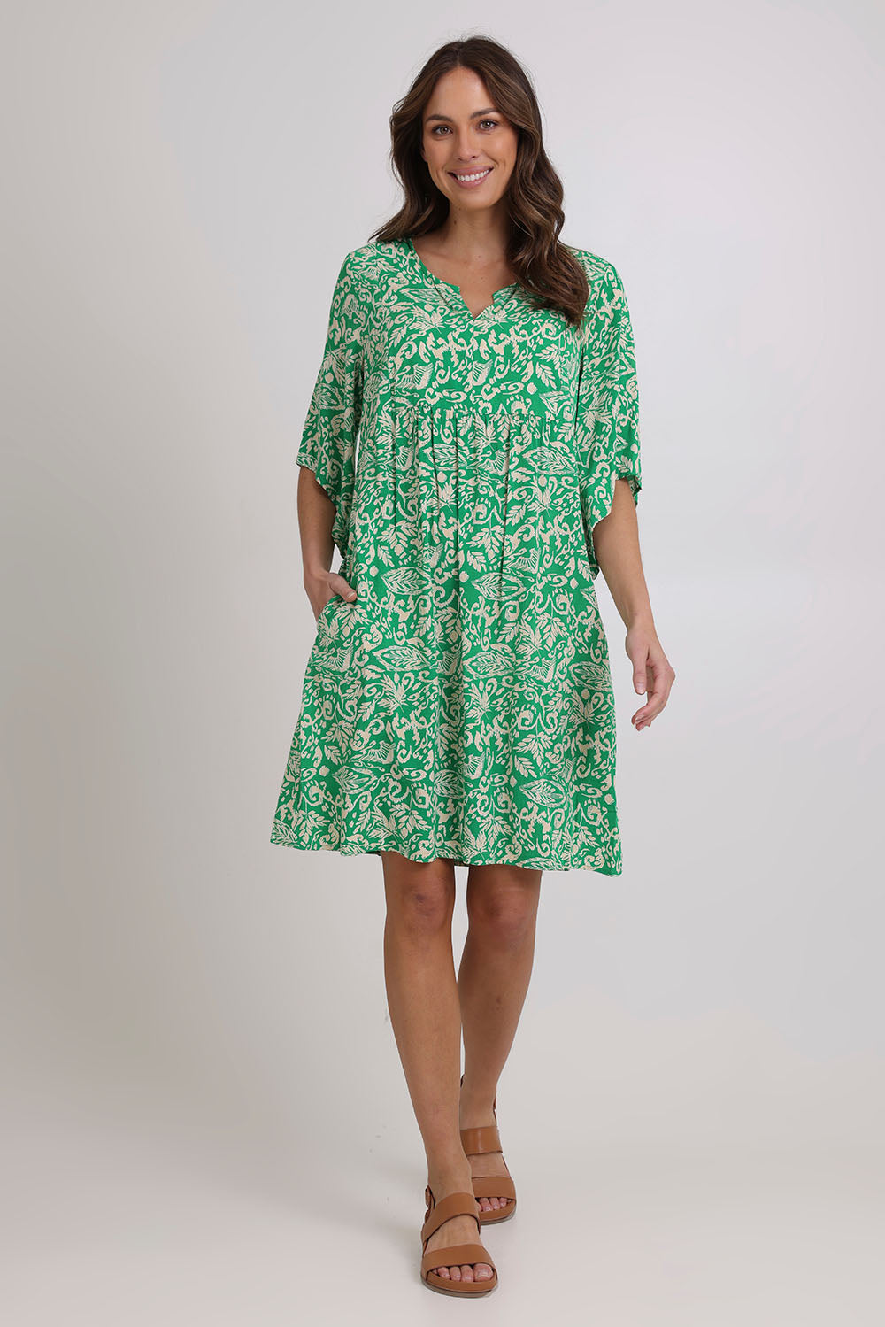 Model Madeline wearing size 10 of the Sun Dress in colour Greentea (Green), from the front, showing the whole outfit