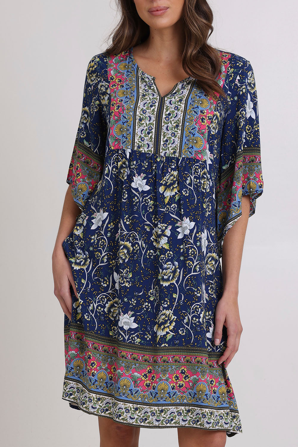 Model Madeline wearing size 10 of the Sun Dress in colour Navyfloral (Blue), from the front, cropped image