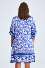 Model Monique wearing size 14 of the Sun Dress in colour Blue (Blue), from the back