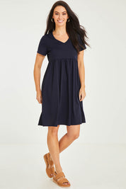 Model Stacey wearing size 10 of the Short Sleeve Holiday Dress in colour Navy (Blue), from the front, showing the whole outfit