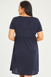 Model Terri-Leigh wearing size 14 of the Short Sleeve Holiday Dress in colour Navy (Blue), from the back