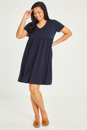Model Terri-Leigh wearing size 14 of the Short Sleeve Holiday Dress in colour Navy (Blue), from the front, showing the whole outfit