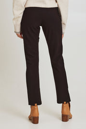 Model Madeline wearing size 10 of the Pencil Pant in colour Mocha, from the back