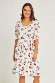 Model Elhana wearing size 10 of the Paradise Print Tunic Dress in colour Print (White), from the front, cropped image