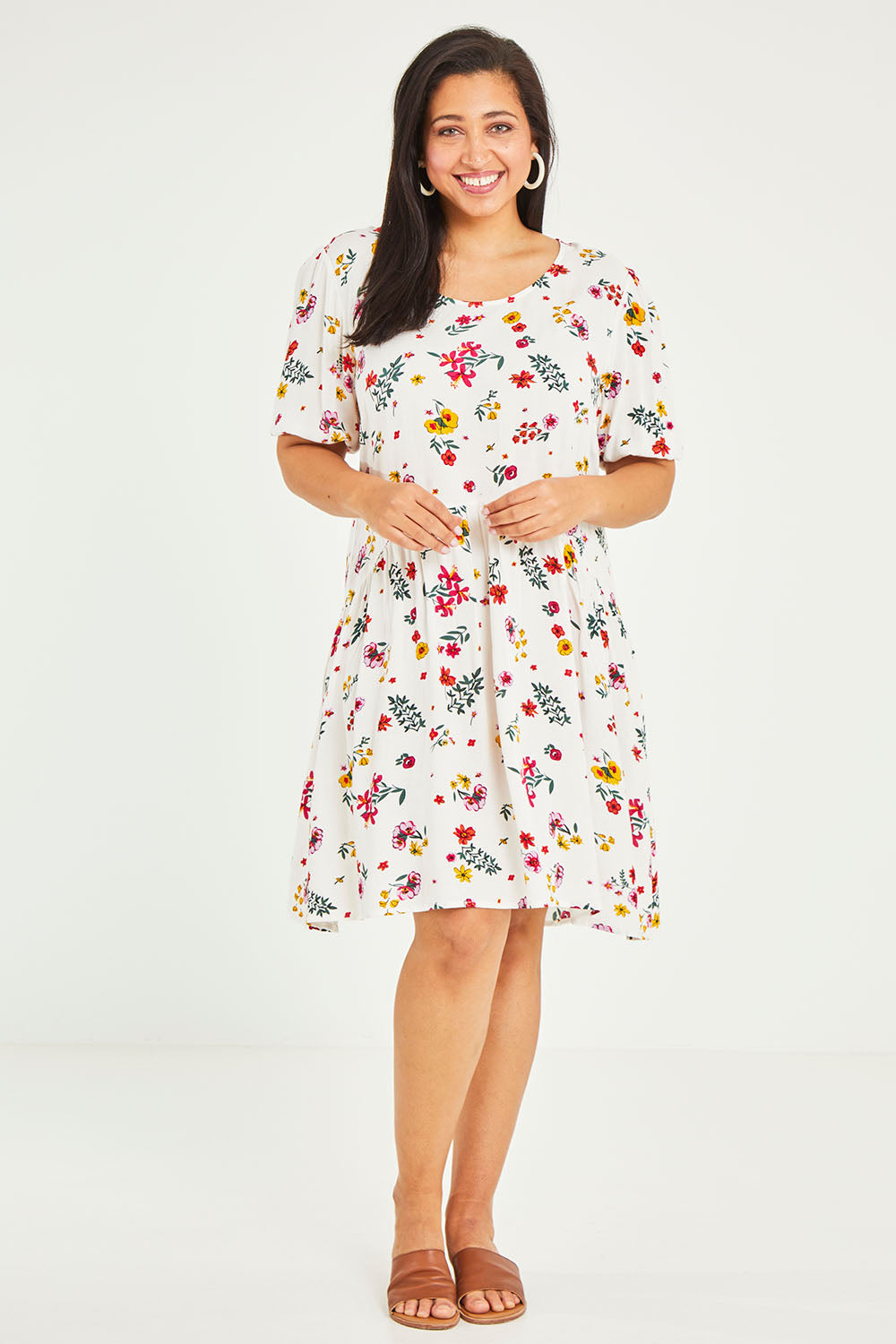 Model Terri-Leigh wearing size 14 of the Paradise Print Tunic Dress in colour Print (White), from the front, showing the whole outfit