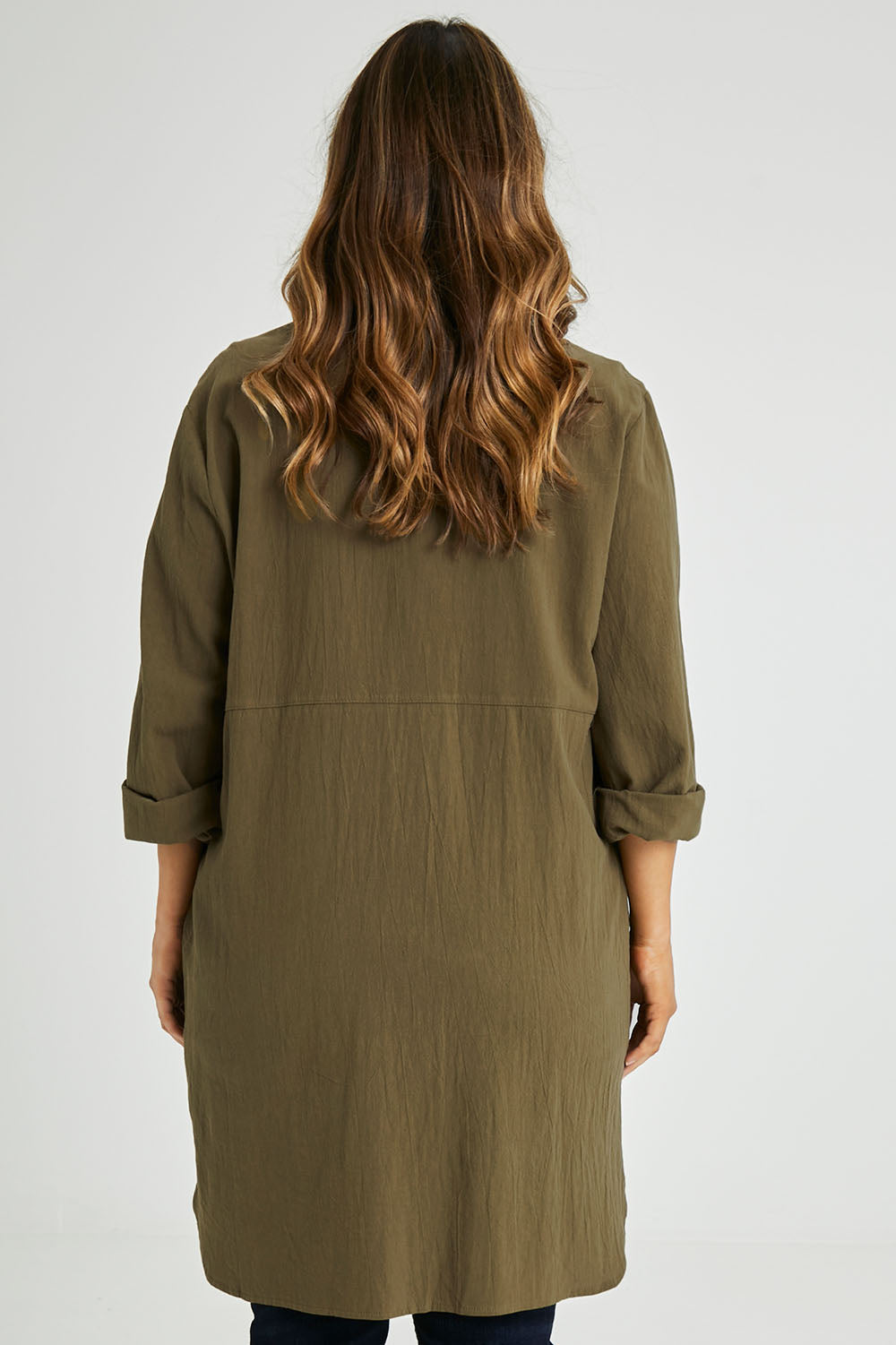Model Laura wearing size 14 of the Splice Print Tunic Shirt in colour Khaki (Green), from the back