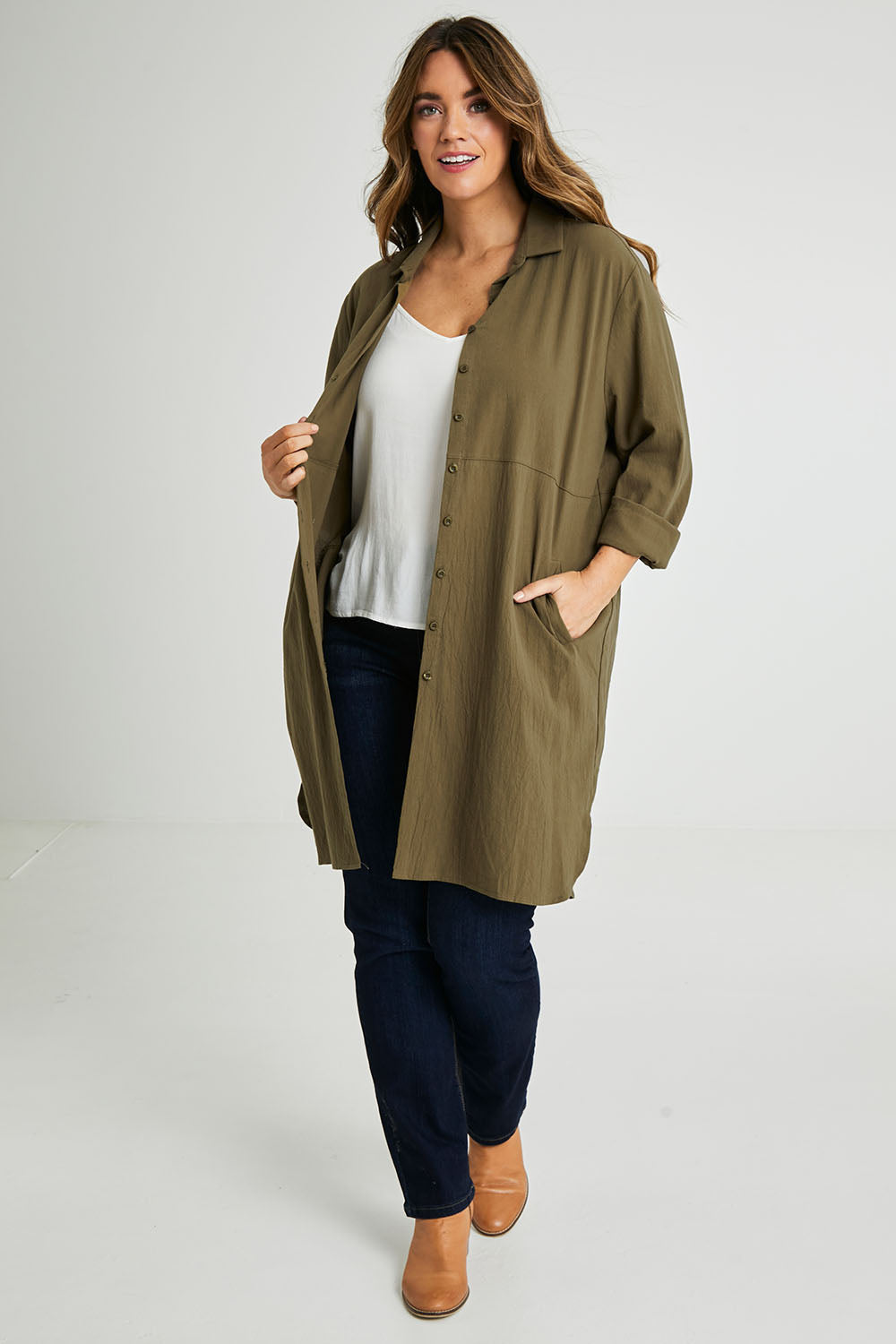 Model Laura wearing size 14 of the Splice Print Tunic Shirt in colour Khaki (Green), from the front, showing the whole outfit